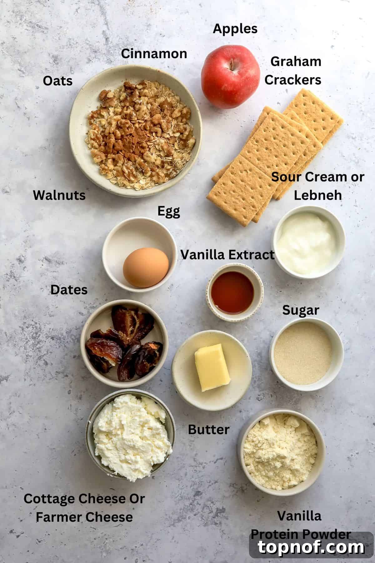 Guilt-Free Protein Cheesecake 3 A selection of fresh ingredients including cottage cheese, eggs, apples, and graham crackers, ready for cheesecake preparation.
