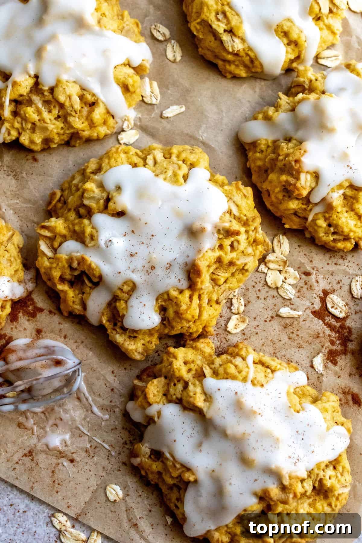Harvest Pumpkin Spice Delights 5 Close-up overhead shot of Pumpkin Pie Spice Cookies on parchment paper with a sprinkle of oats.