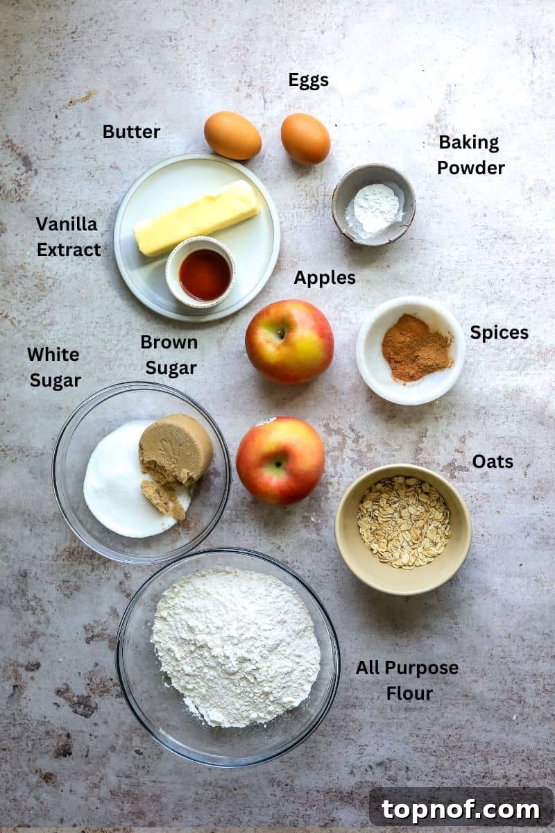 Warm Apple Cinnamon Muffins 3 A vibrant collection of ingredients for making apple streusel muffins, neatly arranged in small bowls and glass containers on a kitchen counter, ready for baking.