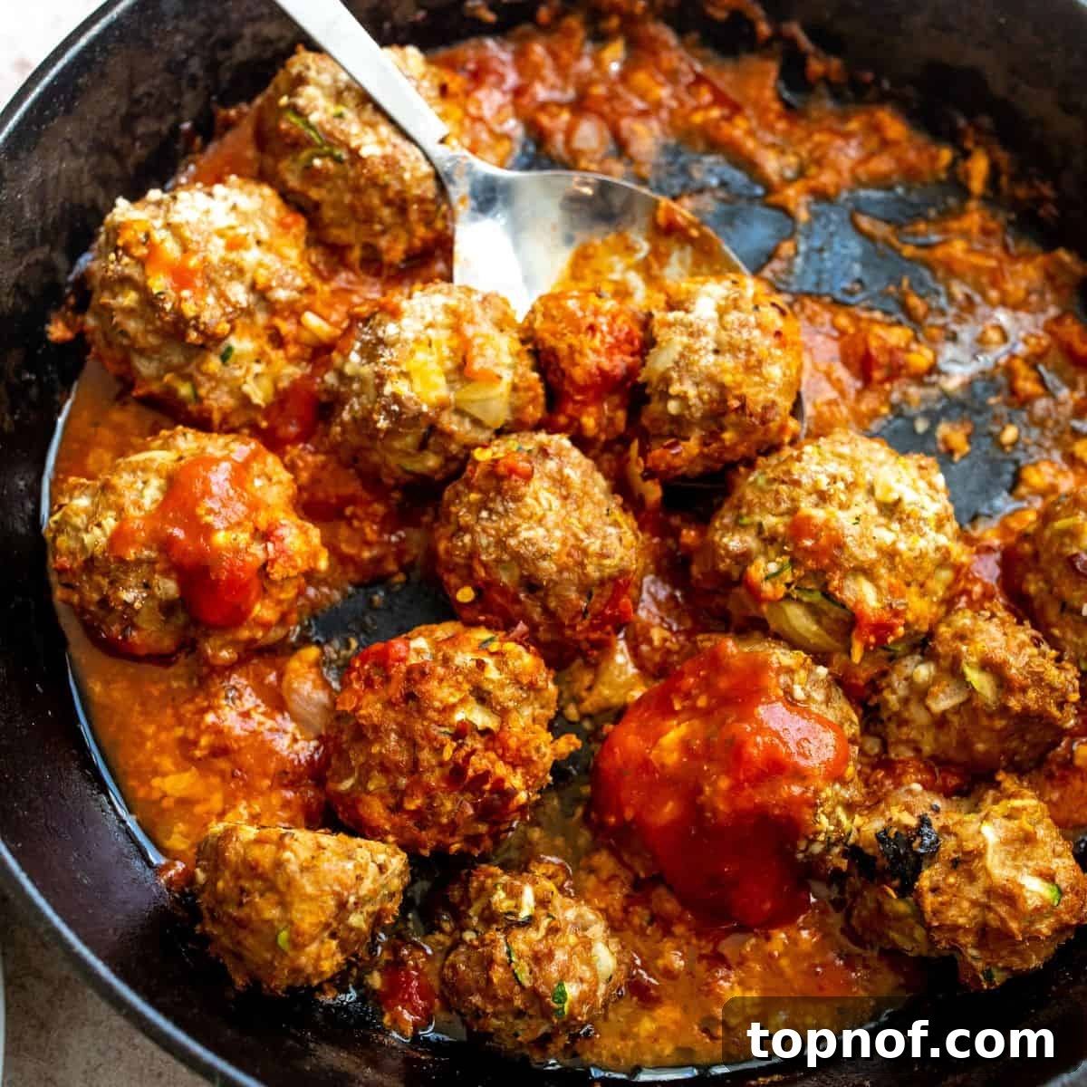Crispy Air Fryer Turkey Meatballs 5 Ground Turkey Meatballs up close in a skillet.