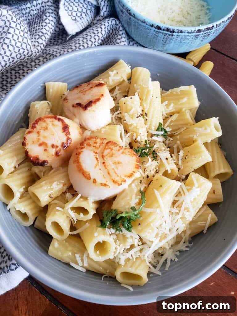 Roman Cheese and Pepper Pasta 6 Healthier Cacio e PePe in a gray bowl with fresh parsley on top for color. seared scallops are on top to show you can top with a protein.