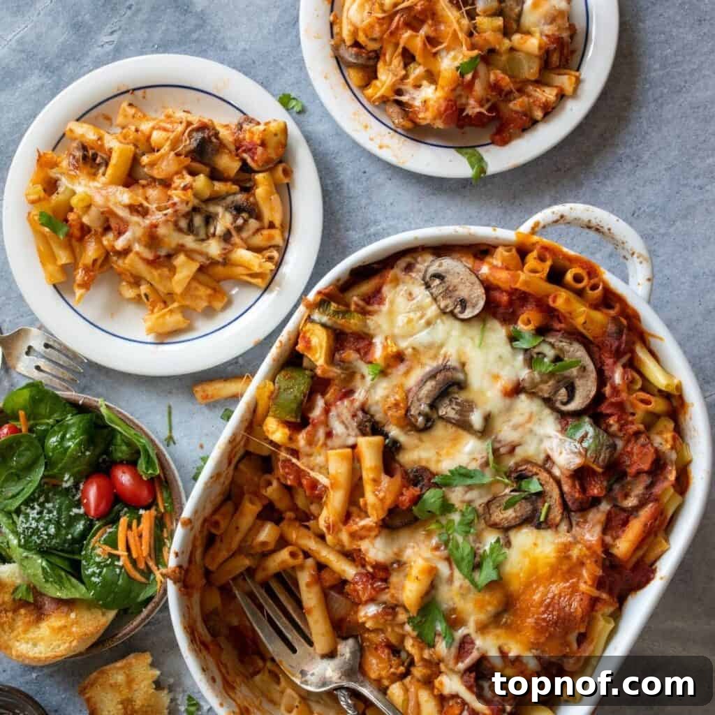A vibrant, close-up shot of the vegetarian pasta bake, garnished with fresh herbs, showcasing the rich sauce and melted cheese.