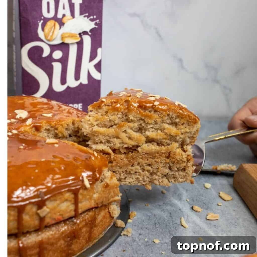A beautifully cooked Caramel Vegan Apple Cake with a slice being cut, showing its moist and tender crumb.