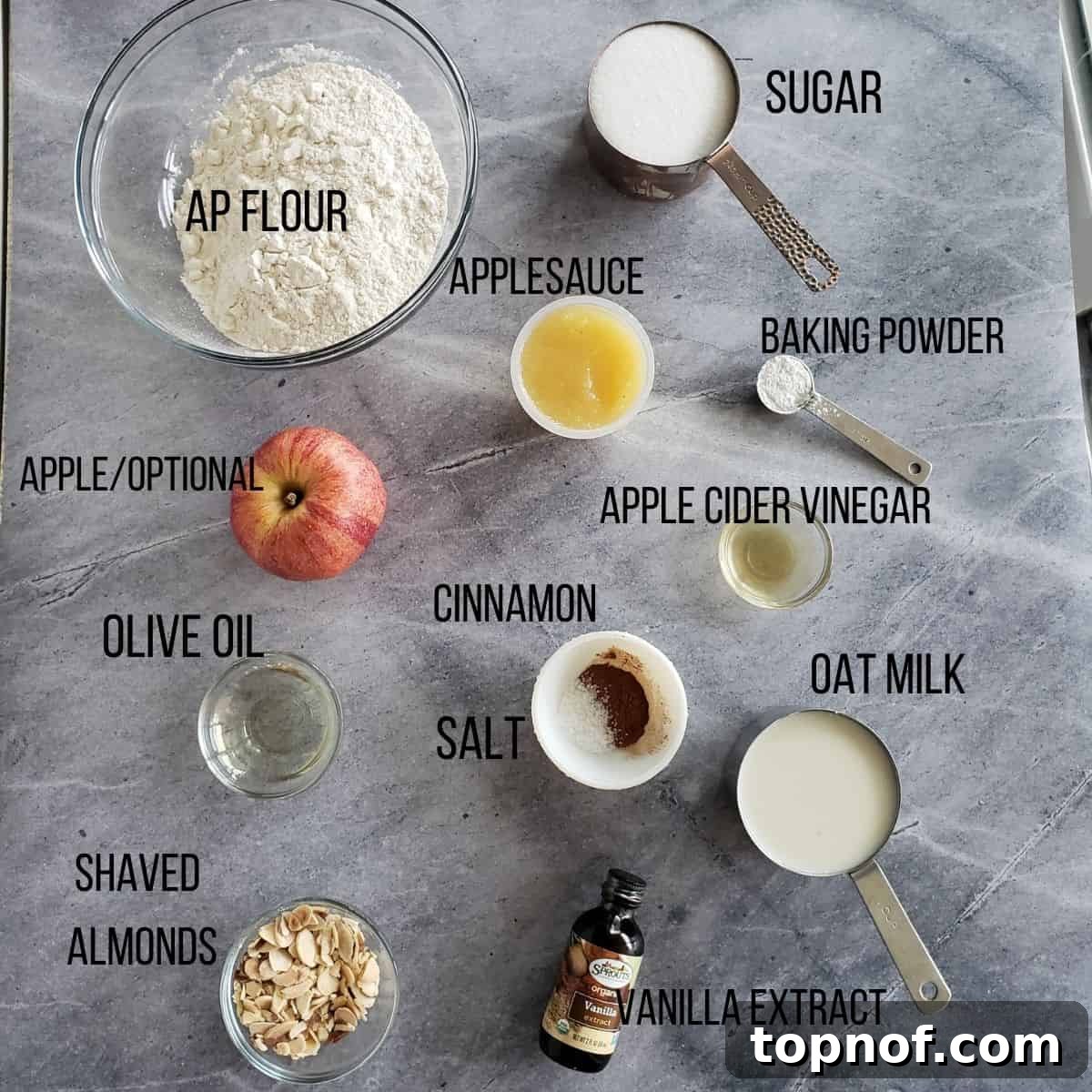 All the ingredients neatly laid out on a table, ready for baking this delicious apple cake.