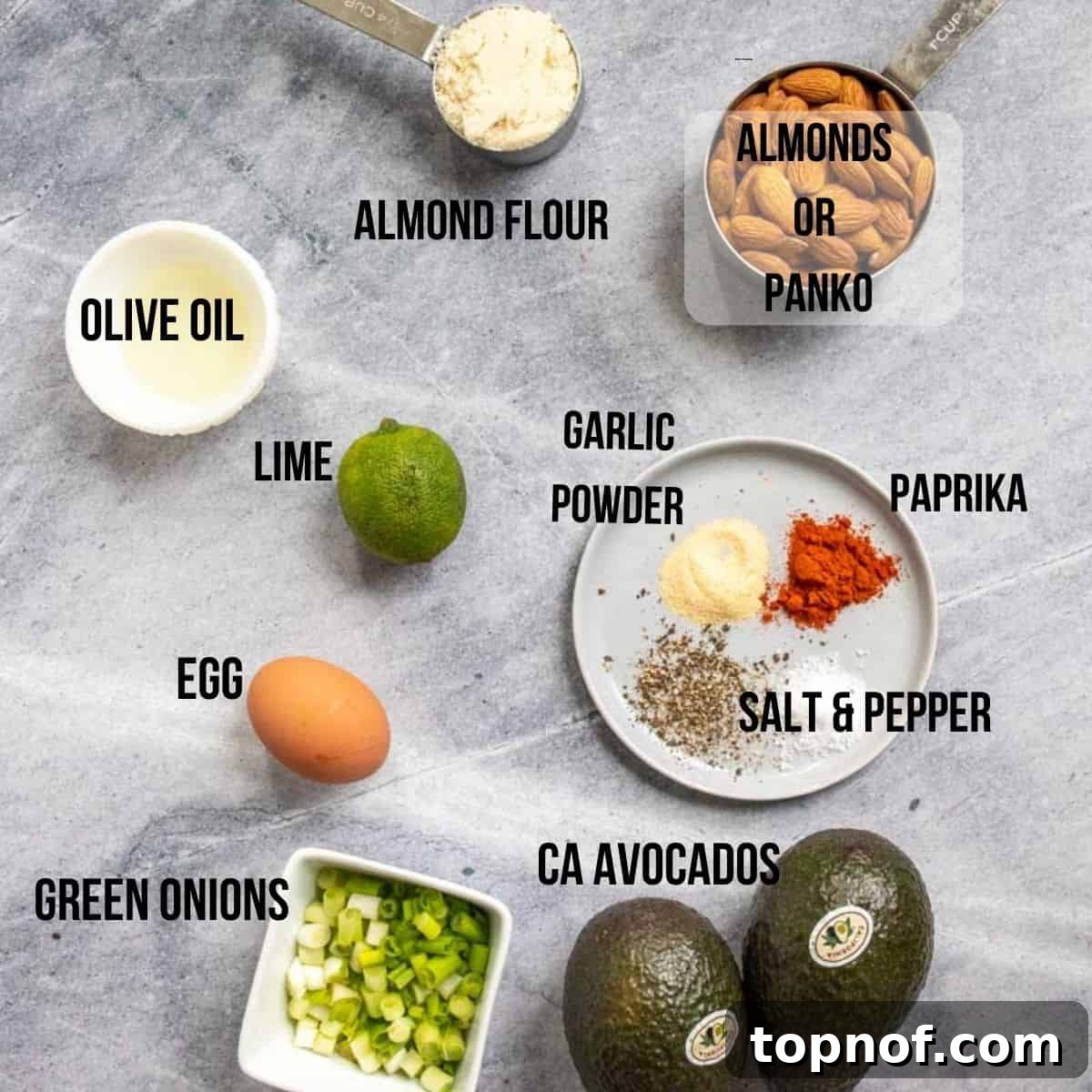 Oven-Crisped Avocado Fries 3 Fresh ingredients laid out on a grey board, including avocados, lime, flour, spices, and an egg, for making avocado fries.