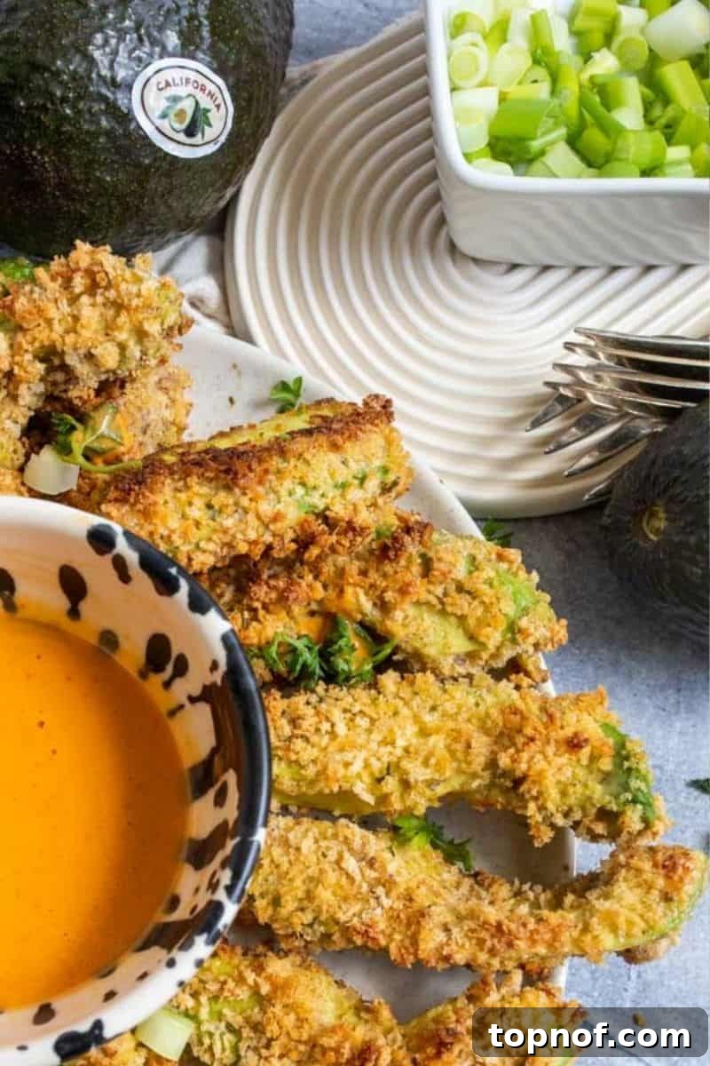 Oven-Crisped Avocado Fries 7 A close-up shot of perfectly baked and crispy avocado fries on a plate, highlighting their golden texture.