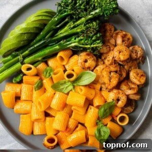 Shrimp and harissa Pasta, a close-up shot of the finished dish, inviting viewers to savor its spicy and savory flavors.