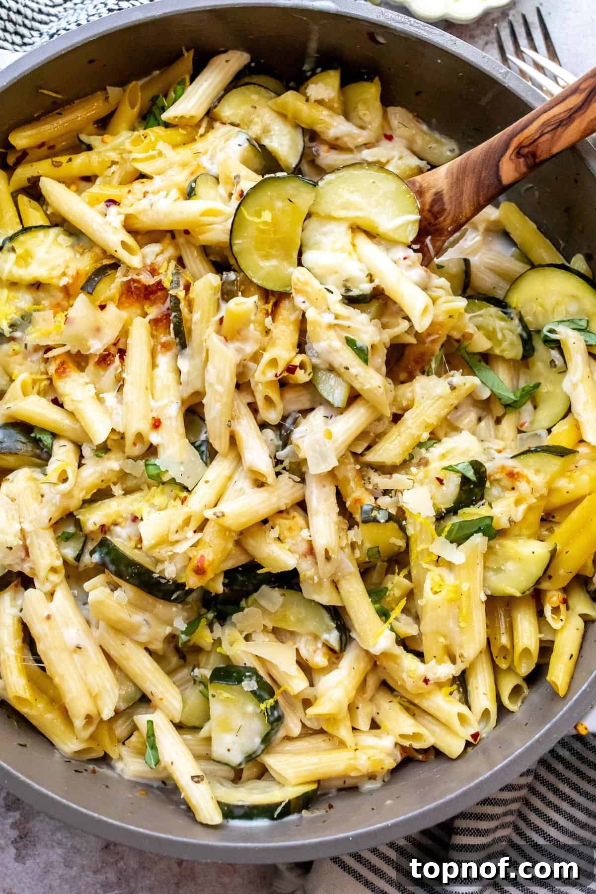 Zesty Pepper Lemon Pasta 6 A large grey skillet generously filled with the finished Lemon Pepper Pasta, invitingly ready to be served.