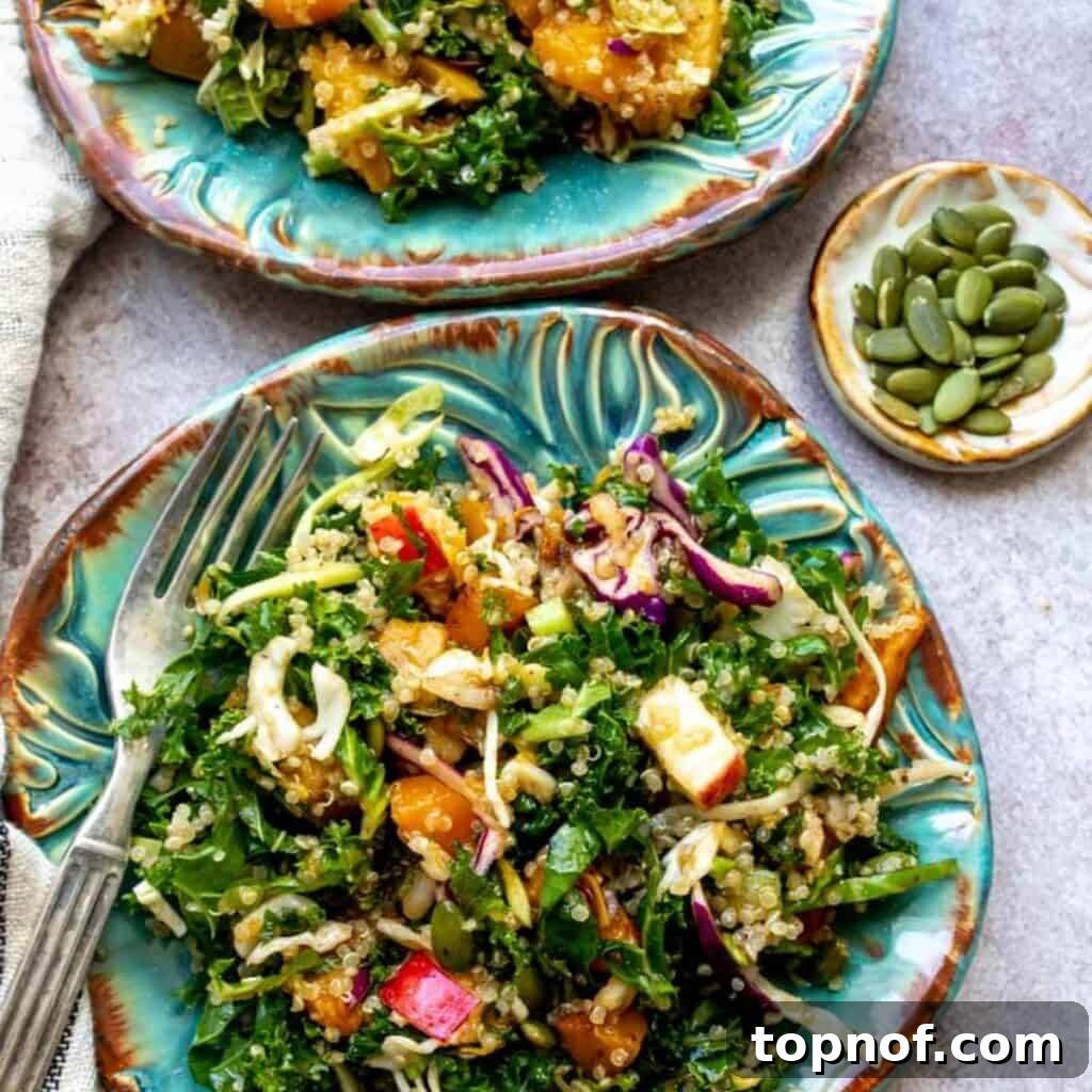 Fall Harvest Salad served on blue plates with forks, showcasing vibrant autumn ingredients.