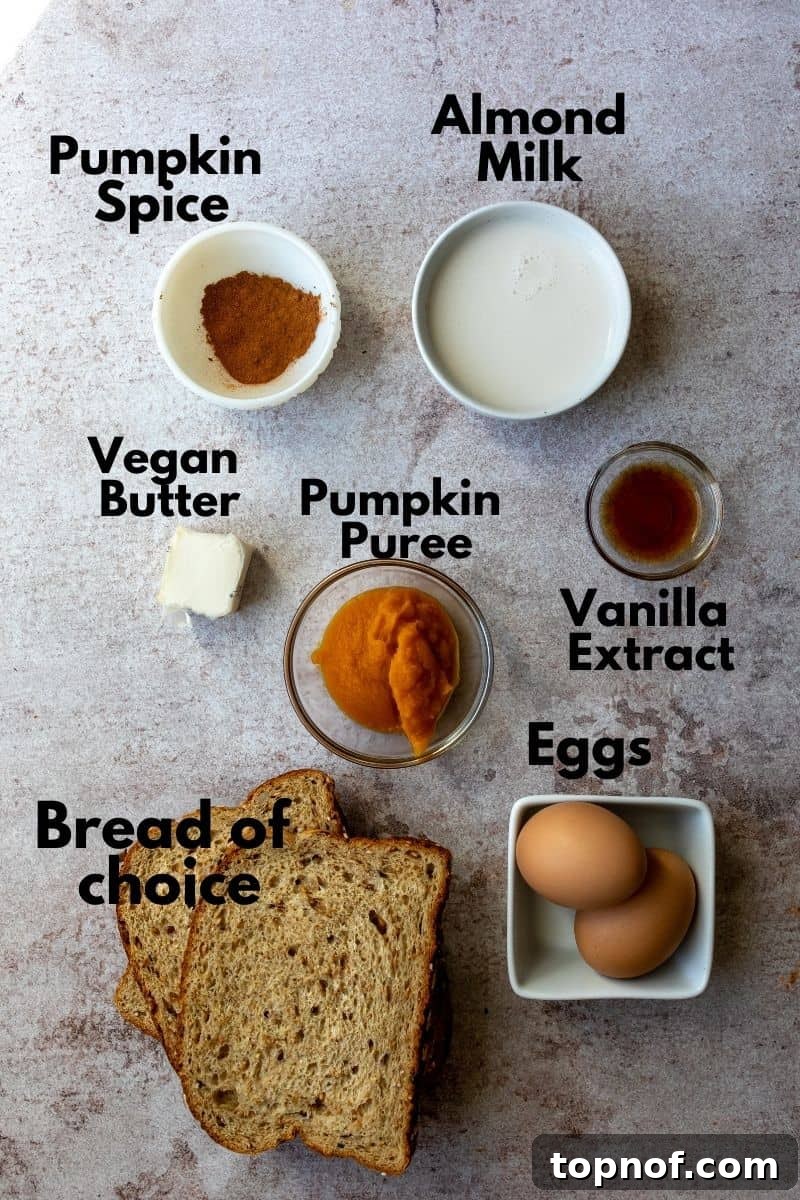 Ultimate Pumpkin Spice French Toast 3 Bowls of pumpkin puree, eggs, milk, vanilla, and pumpkin spice on a counter, ready for French toast preparation.