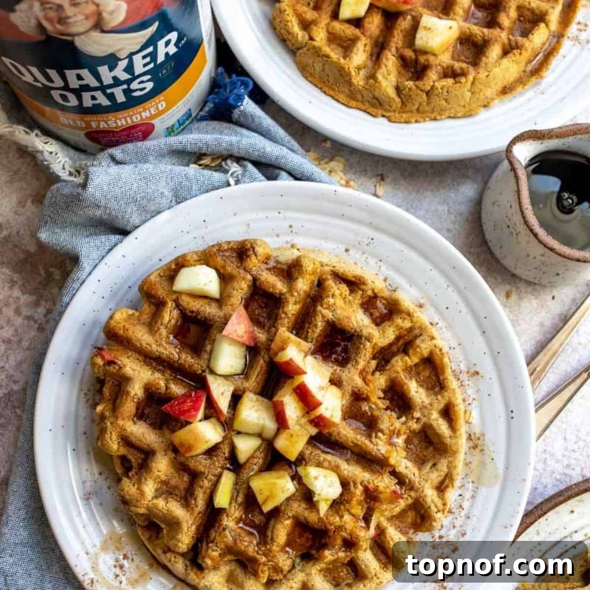 Apple Pie Waffles 2 A beautifully plated stack of golden brown apple waffles, drizzled with maple syrup and garnished with fresh apple slices, ready to be enjoyed for a delicious breakfast or brunch.