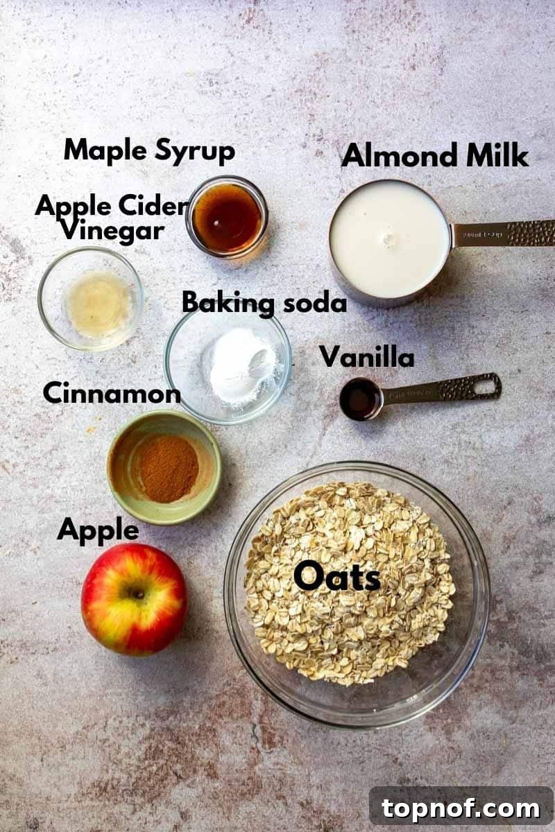 Apple Pie Waffles 4 A flat lay photo showing all the fresh ingredients needed to make apple waffles, including oats, apples, spices, and milk.