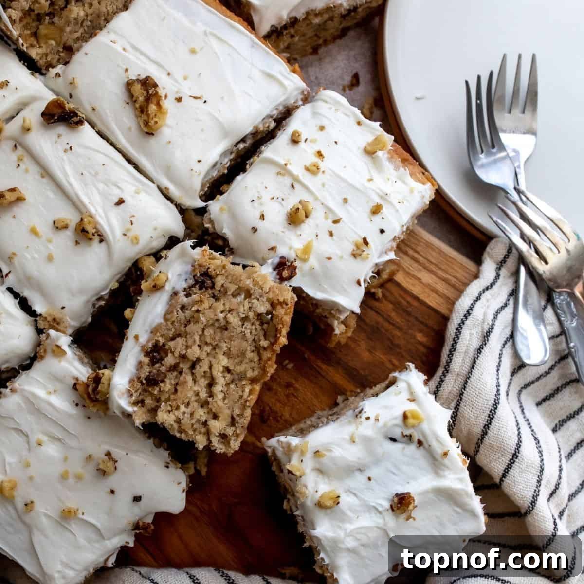 Ultimate Vegan Banana Cake 7 Close-up photo of the vegan banana cake with crushed walnuts sprinkled on top of the frosting.