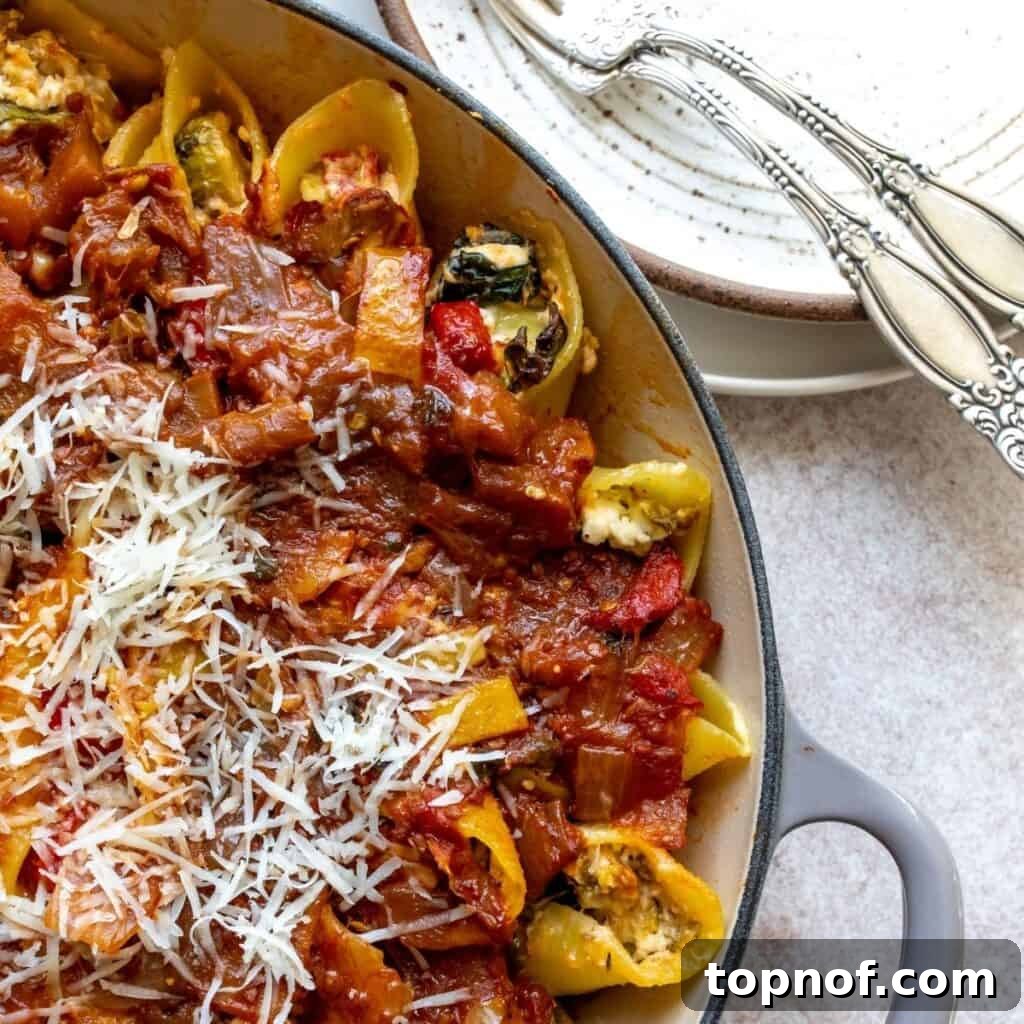 Up close photo of Veggie Stuffed Shells With Baked Feta, garnished with fresh herbs.