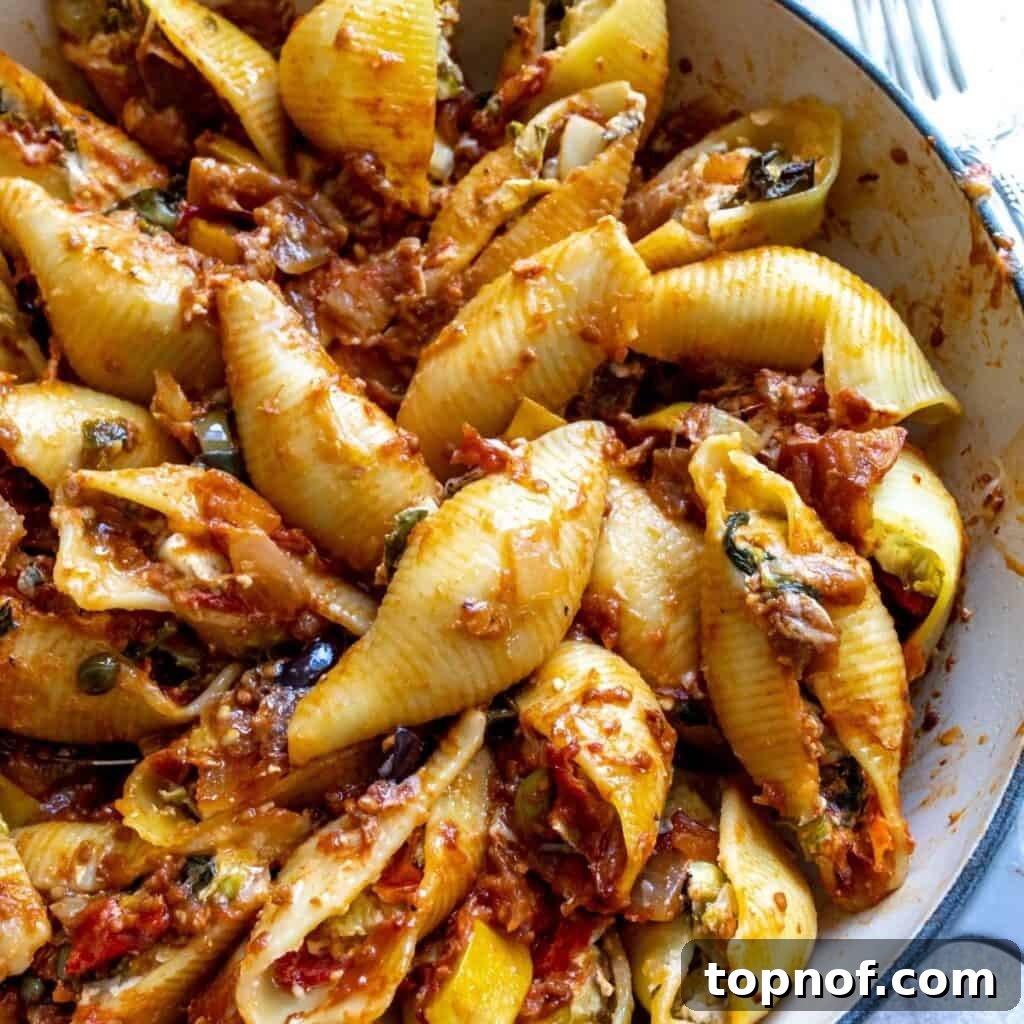 Up close photo of veggie stuffed shells with baked feta, served and ready to eat.