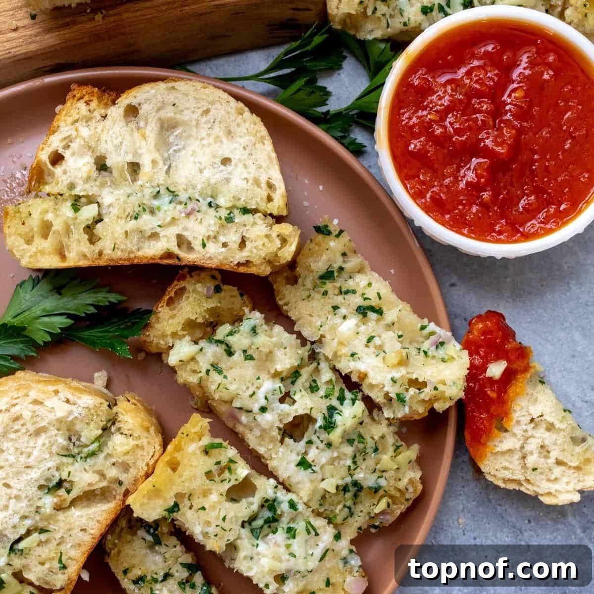 Crispy Air Fryer Garlic Bread 2 Air Fryer Garlic Bread up close with marinara, showcasing its crispy texture.