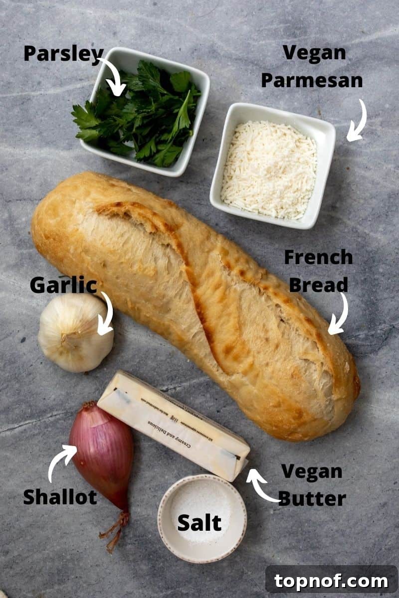 Crispy Air Fryer Garlic Bread 3 Easy Air Fryer Garlic Bread ingredients neatly arranged on a grey board.