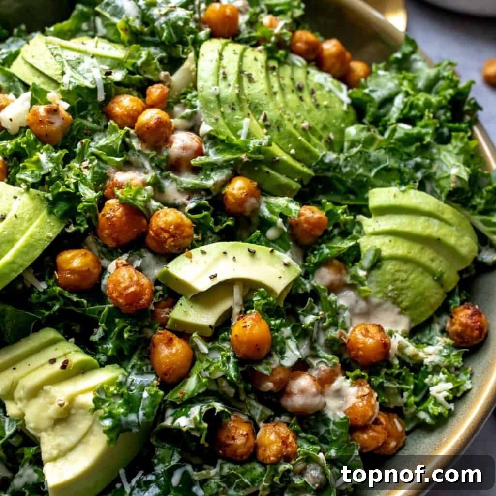 Zesty Lemon Kale Caesar 5 Close-up view of the finished salad with creamy dressing and avocado slices.