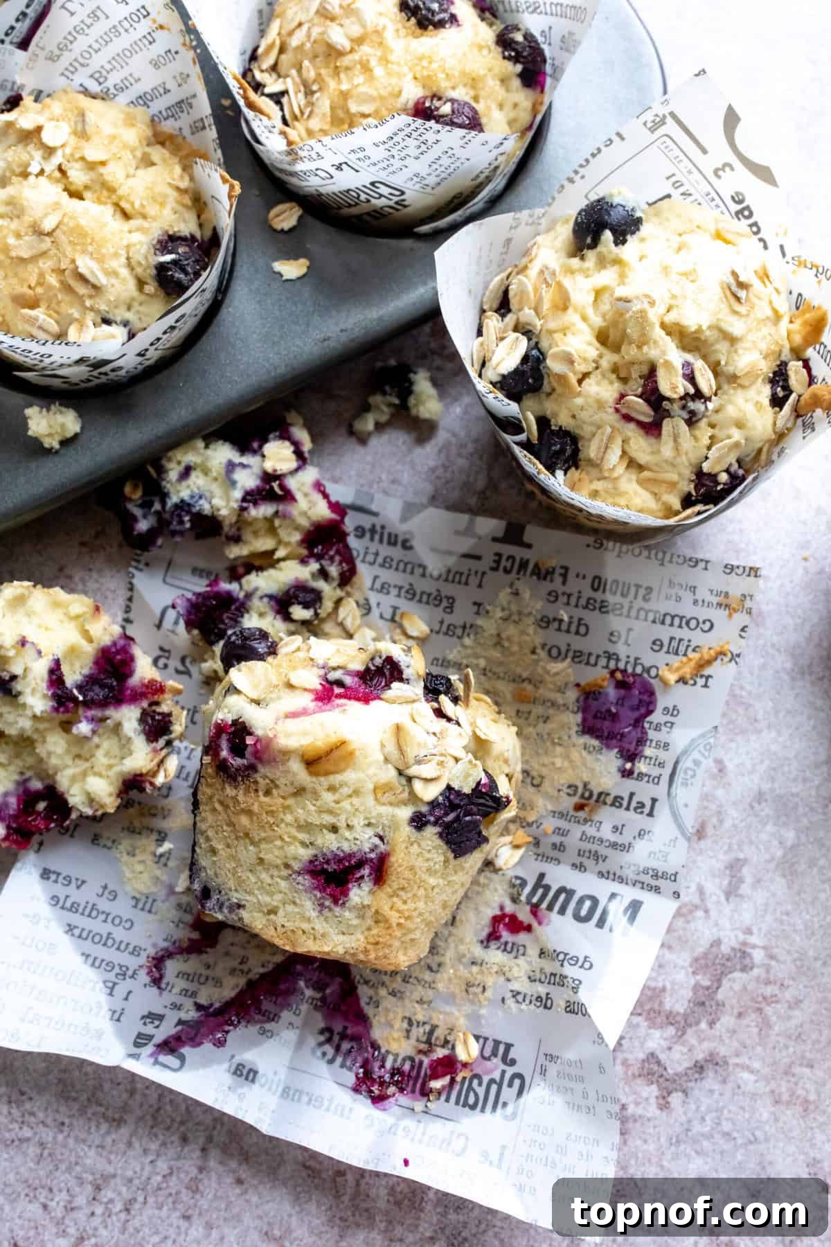 Vegan Blueberry Bliss Muffins 2 Up close photo of golden-brown dairy-free blueberry muffins, showing their fluffy texture and abundant blueberries.