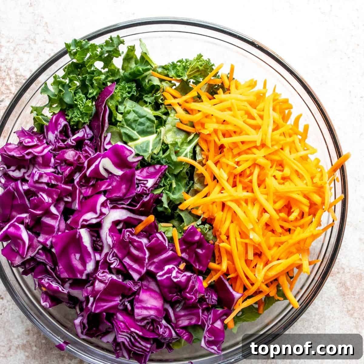 Vibrant Kale Slaw Perfection 5 A large serving bowl overflowing with freshly mixed, vibrant kale slaw, ready to be enjoyed.