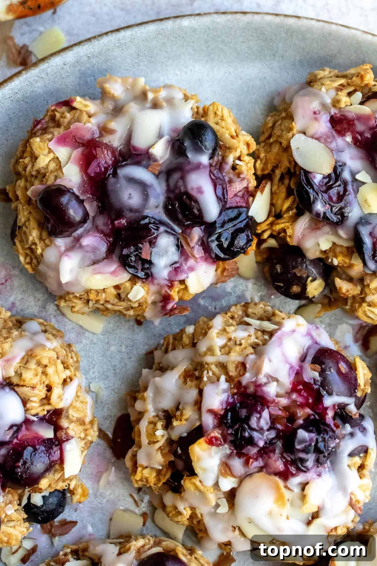 Wholesome Blueberry Oat Delights 6 Close-up view of freshly baked Blueberry Oat Cookies on a plate, adorned with a sweet icing drizzle.