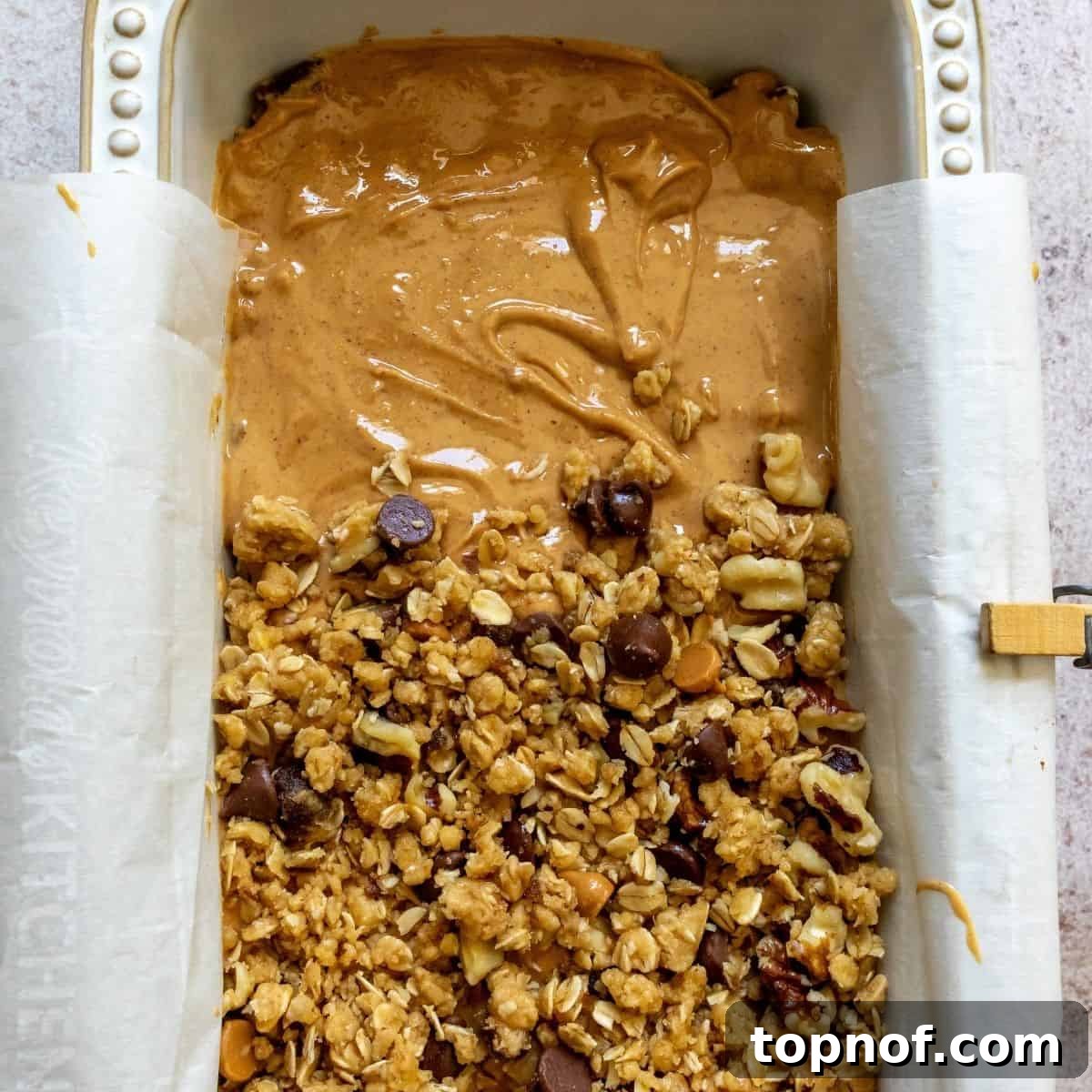 Fudgy Peanut Butter Chocolate Oat Bars 5 The base layer of Chocolate Peanut Butter Oatmeal Bar dough pressed into a baking dish, ready for baking.