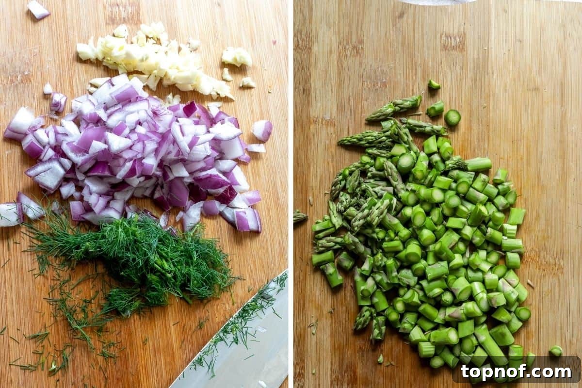 A collage of freshly chopped vegetables including dill, red onion, garlic, and asparagus on a wooden cutting board, prepped for the mustard potato salad.