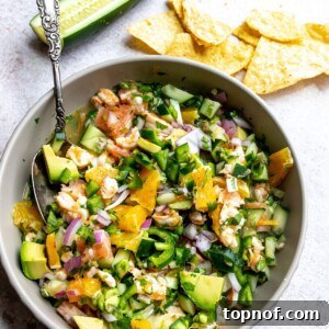 Mexican Shrimp Ceviche in a grey bowl, garnished with cilantro and lime.
