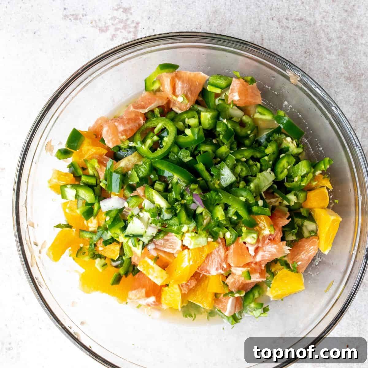 A large glass bowl filled with colorful Mexican Shrimp Ceviche, showing all the ingredients combined, ready for serving.