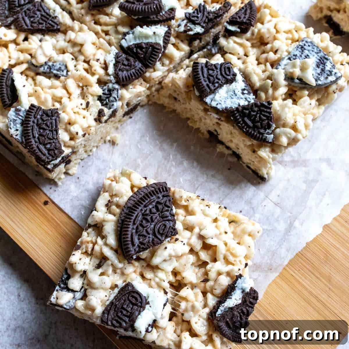 Up close photo of Oreo Rice Krispie Treats on a cutting board, showcasing their delicious texture.