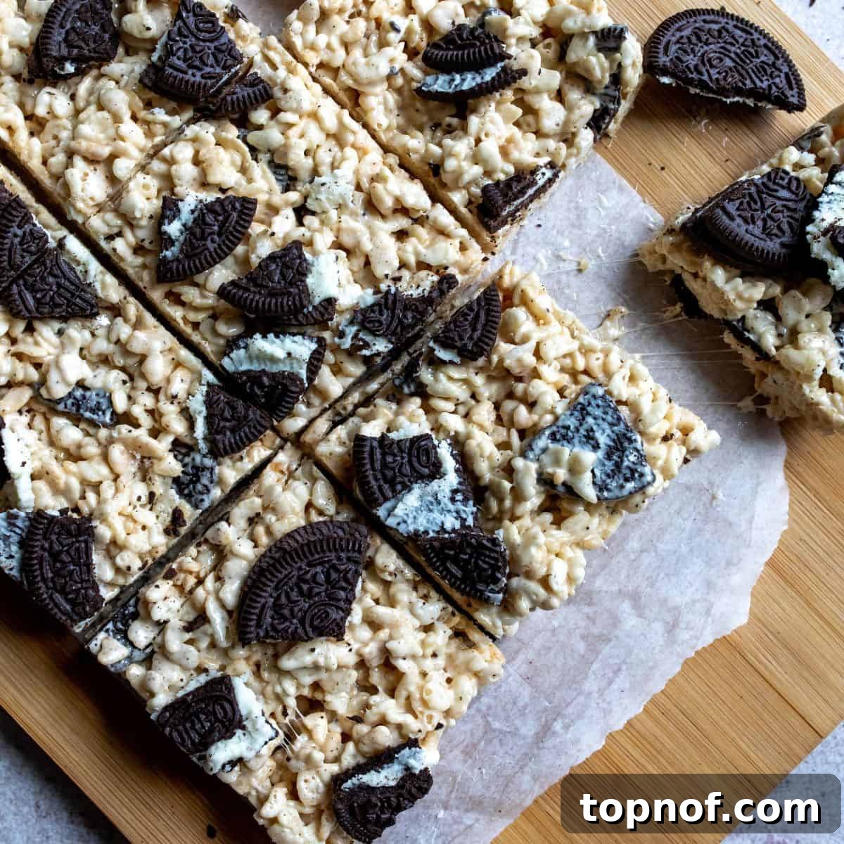 Oreo Rice Krispie Treats cut into perfect squares on a cutting board.