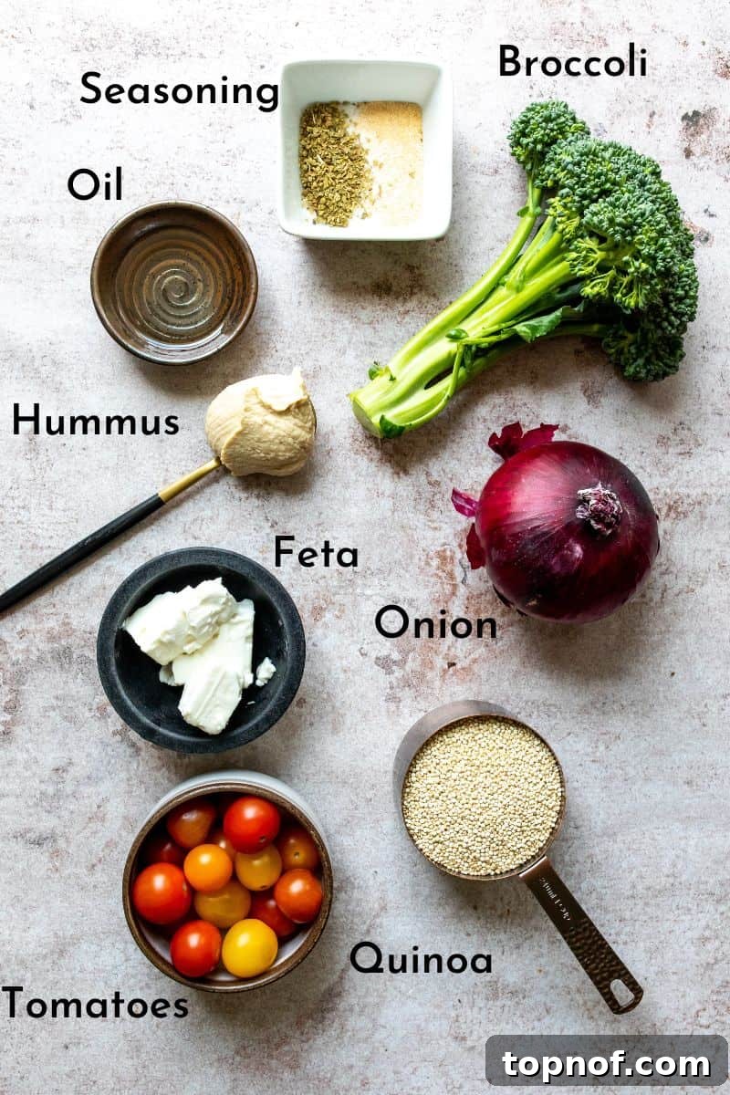 Vibrant Quinoa & Roasted Broccoli Power Bowls 3 A vibrant selection of Quinoa Veggie Bowl ingredients, including fresh broccoli, red onion, cherry tomatoes, feta, and quinoa, beautifully arranged on a kitchen counter, ready for preparation.
