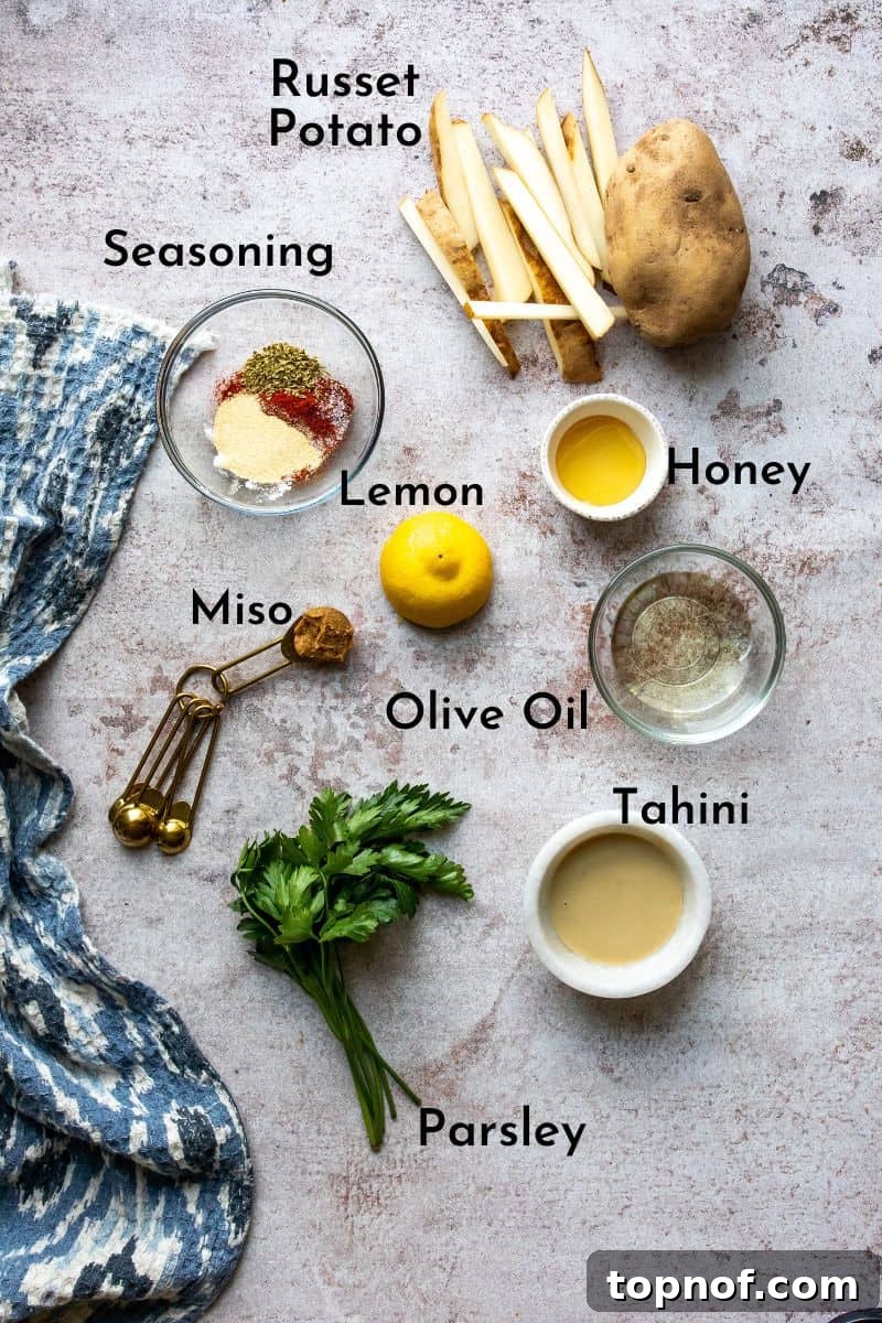 Ultimate Crispy Homemade Fries 3 Crispy Homemade Fries Ingredients neatly arranged on a kitchen counter, ready for preparation.