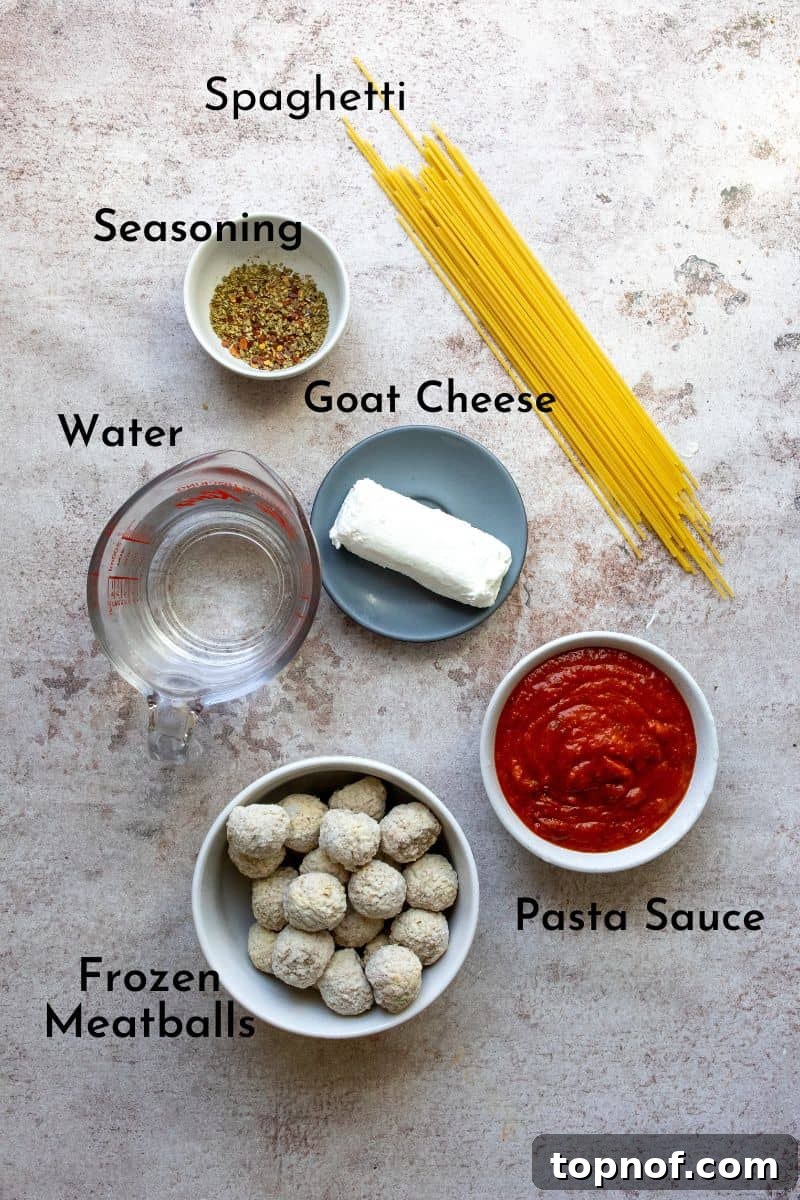 Cheesy Baked Spaghetti and Meatball Casserole 3 Baked Spaghetti And Meatballs ingredients laid out on a kitchen counter in small dishes.