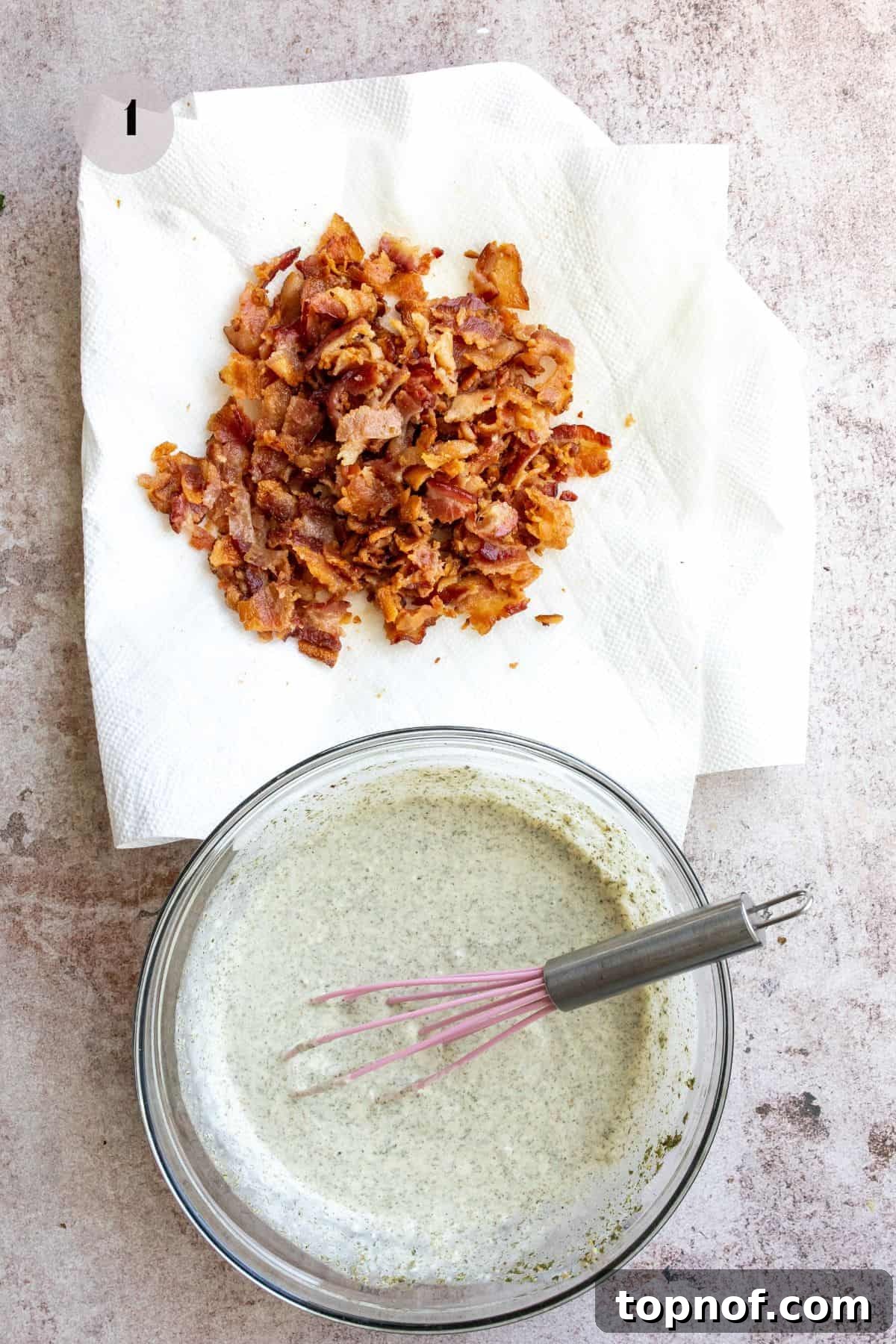 Savory BLT Pasta Toss 4 Crispy bacon draining on paper towels next to a bowl of creamy BLT pasta salad dressing with a whisk.