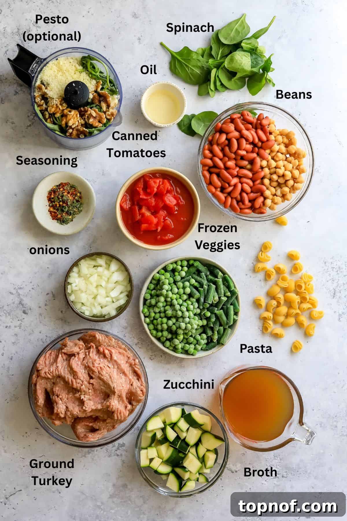 Hearty Turkey Minestrone 3 A curated selection of fresh ingredients including ground turkey, colorful vegetables, beans, and pasta, neatly arranged on a counter, ready for Minestrone Soup preparation.