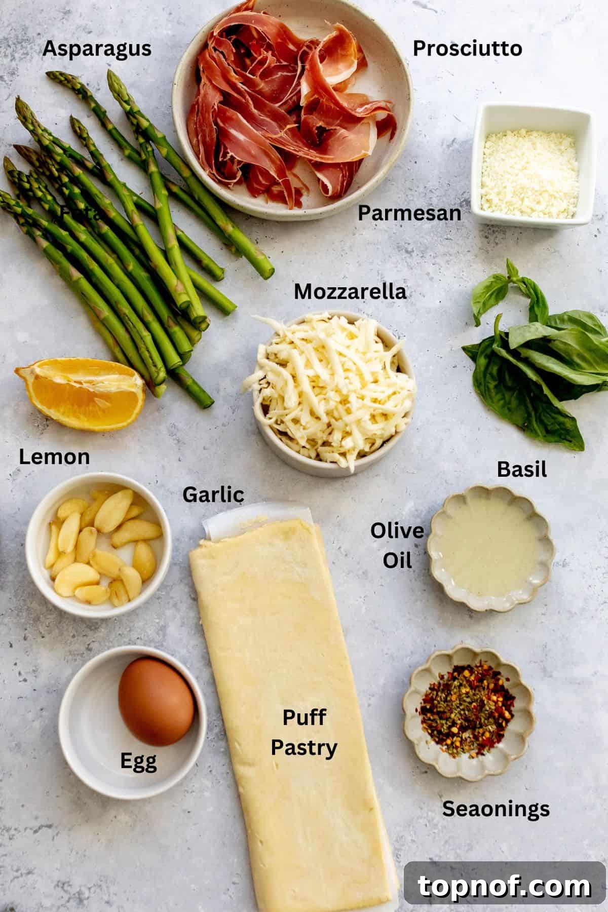 Golden Asparagus Bites 3 Fresh ingredients laid out on a white counter in small bowls, ready for cooking.