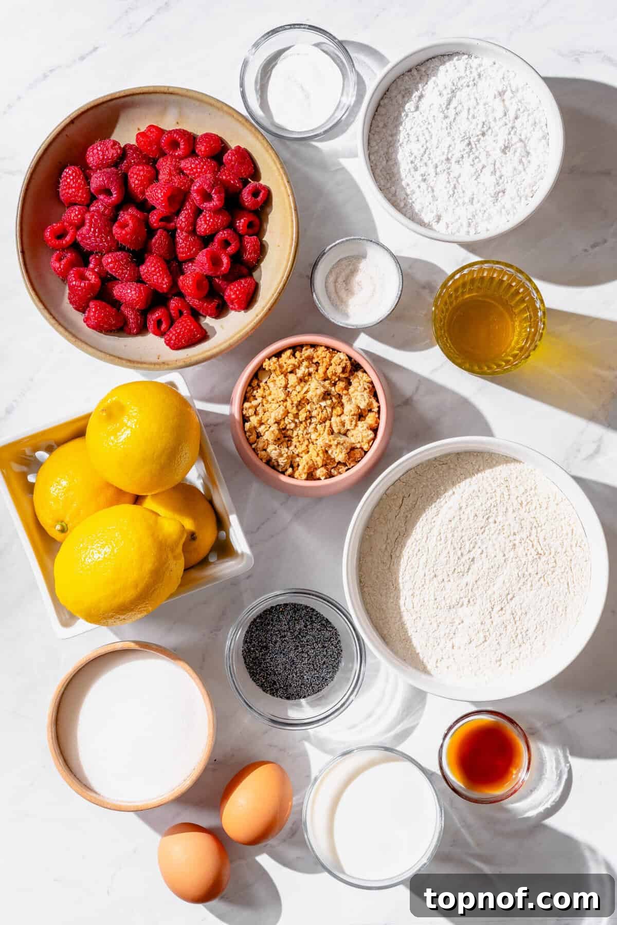 Sunshine Lemon Raspberry Muffins 3 Ingredients for fluffy lemon raspberry muffins laid out on a table