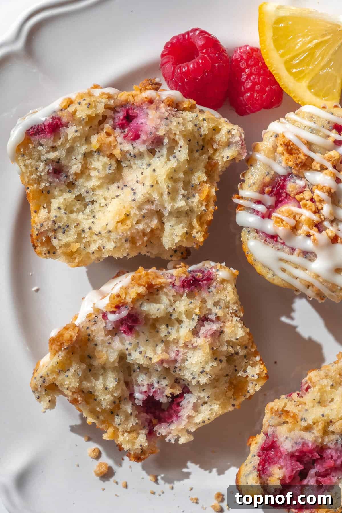 Sunshine Lemon Raspberry Muffins 5 Beautifully glazed fluffy lemon raspberry muffins on a wire rack