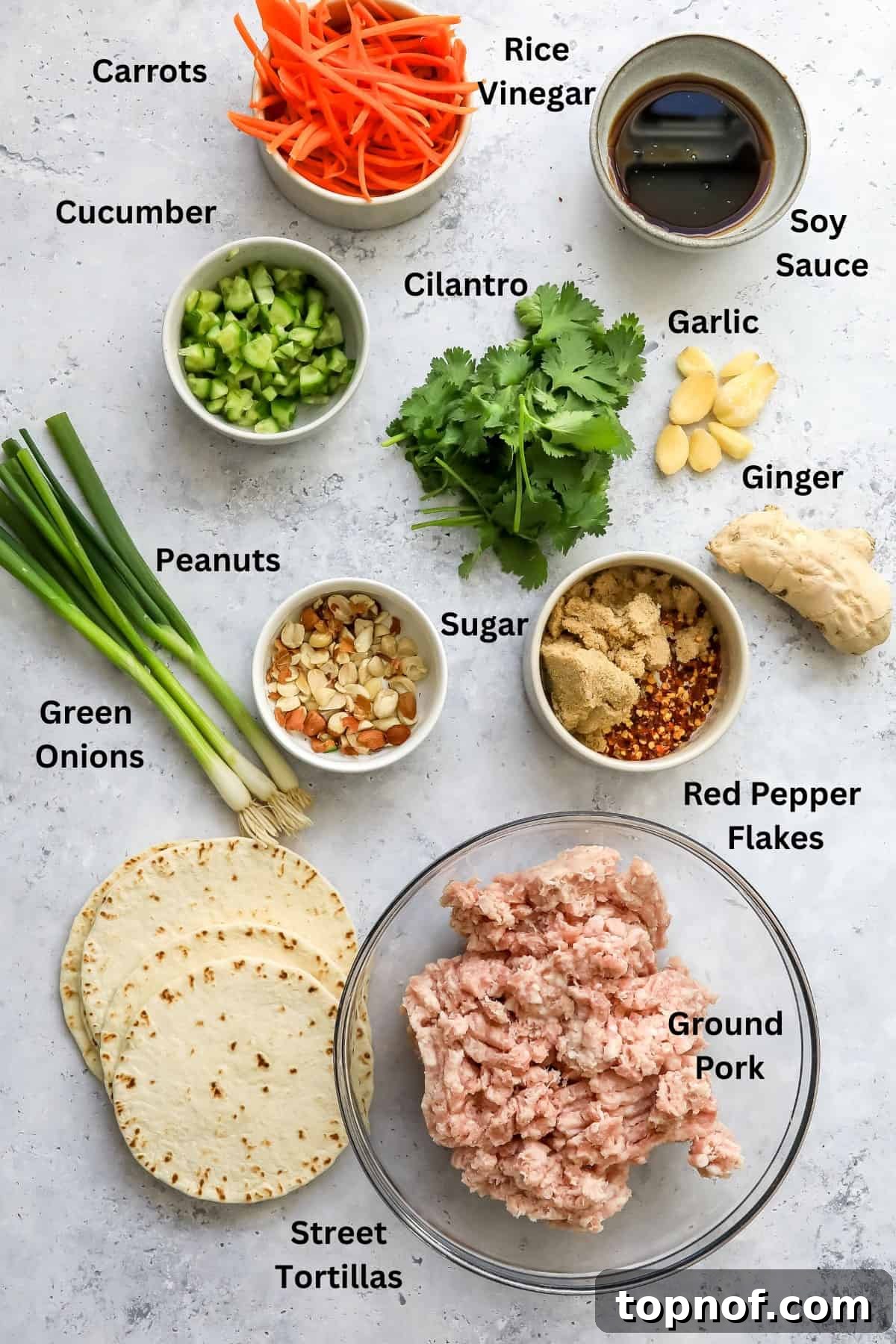 A selection of fresh ingredients for making dumpling tacos, neatly arranged in small glass bowls, highlighting their quality and readiness for preparation.