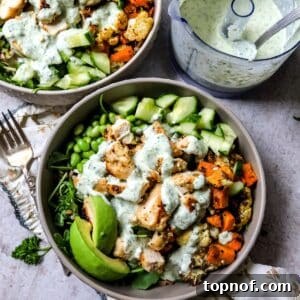Lemon Garlic Chicken Grain Bowls with Roasted Veggies 6 Grey bowls with chicken power bowls in them and dressed with sauce.