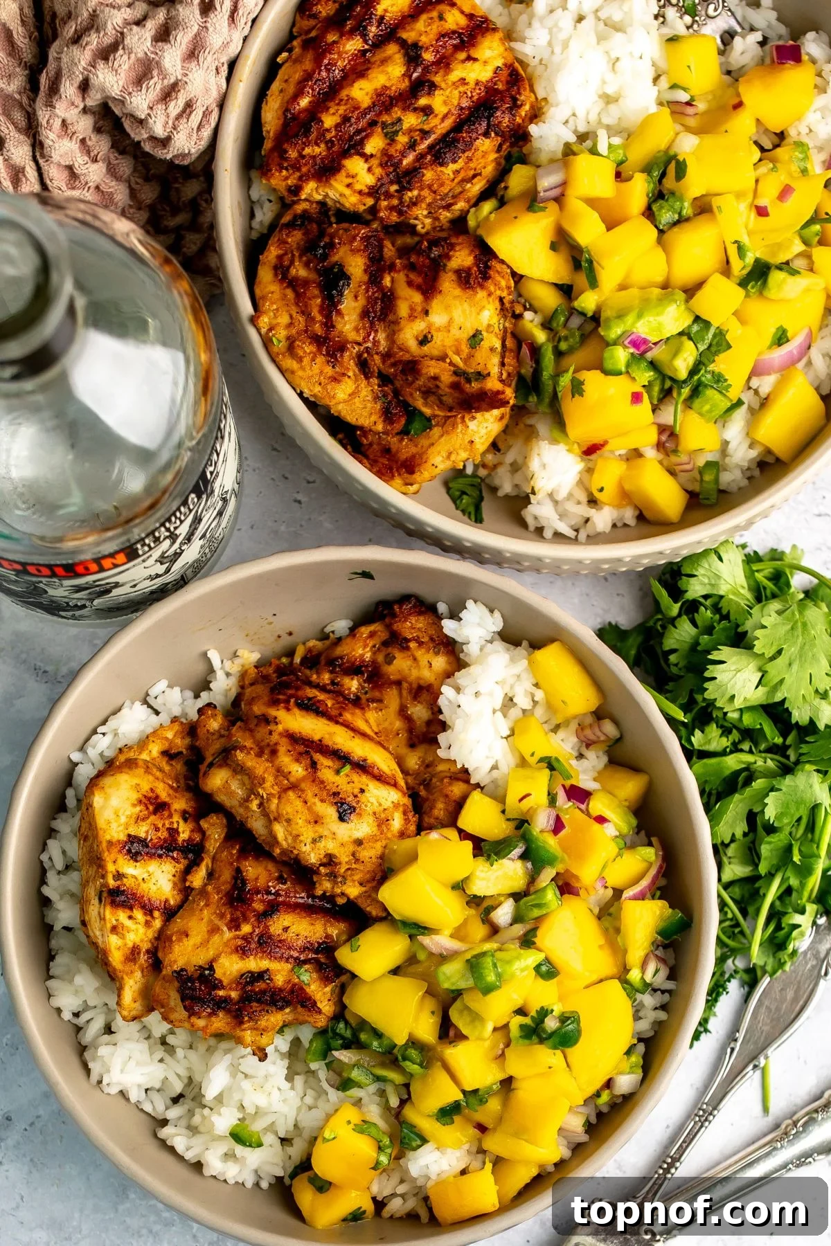 Citrus Tequila-Lime Chicken Recipe for Grilled Weeknight Meals 5 Tequila lime chicken served over rice and with mango salsa.