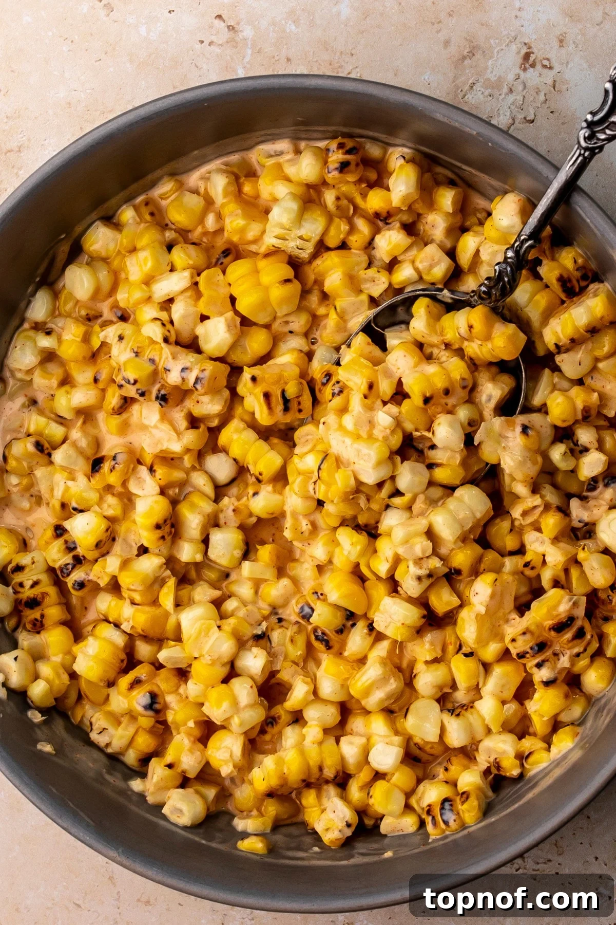 Street Corn Chicken Rice Bowls with Lime Crema 5 Grey bowl with creamy corn dressed in sauce.