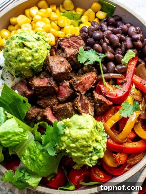 Street Corn Chicken Rice Bowls with Lime Crema 8 Ceramic bowl with steak and rice in it. Lots of toppings and a fork.
