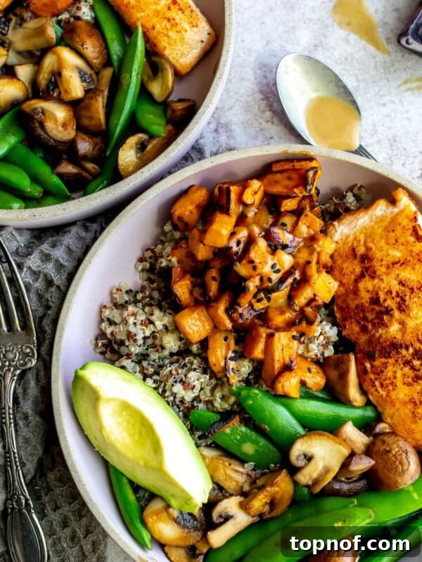 Street Corn Chicken Rice Bowls with Lime Crema 9 Two bowls with salmon, fresh veggies and quinoa.