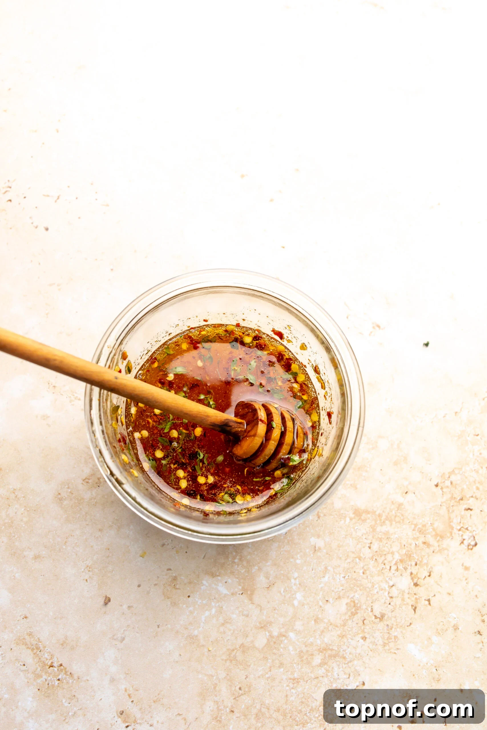 Hot Honey-Glazed Salmon with Crispy Skin 4 Hot honey in a small jar with a honey stick.