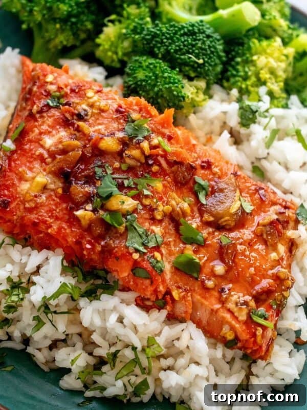 Hot Honey-Glazed Salmon with Crispy Skin 9 green plate with firecracker salmon on top and broccoli.