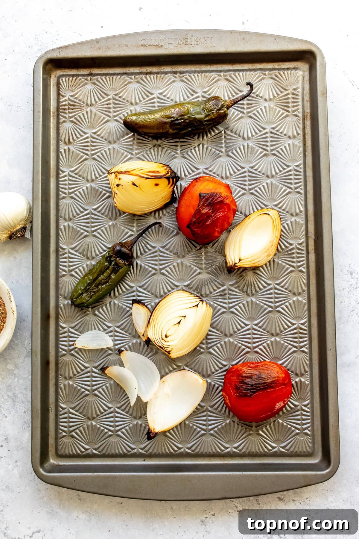 Slow Cooker Beef Birria Tacos with Dipping Consomme 5 The roasted veggies on a sheet pan after roasting.