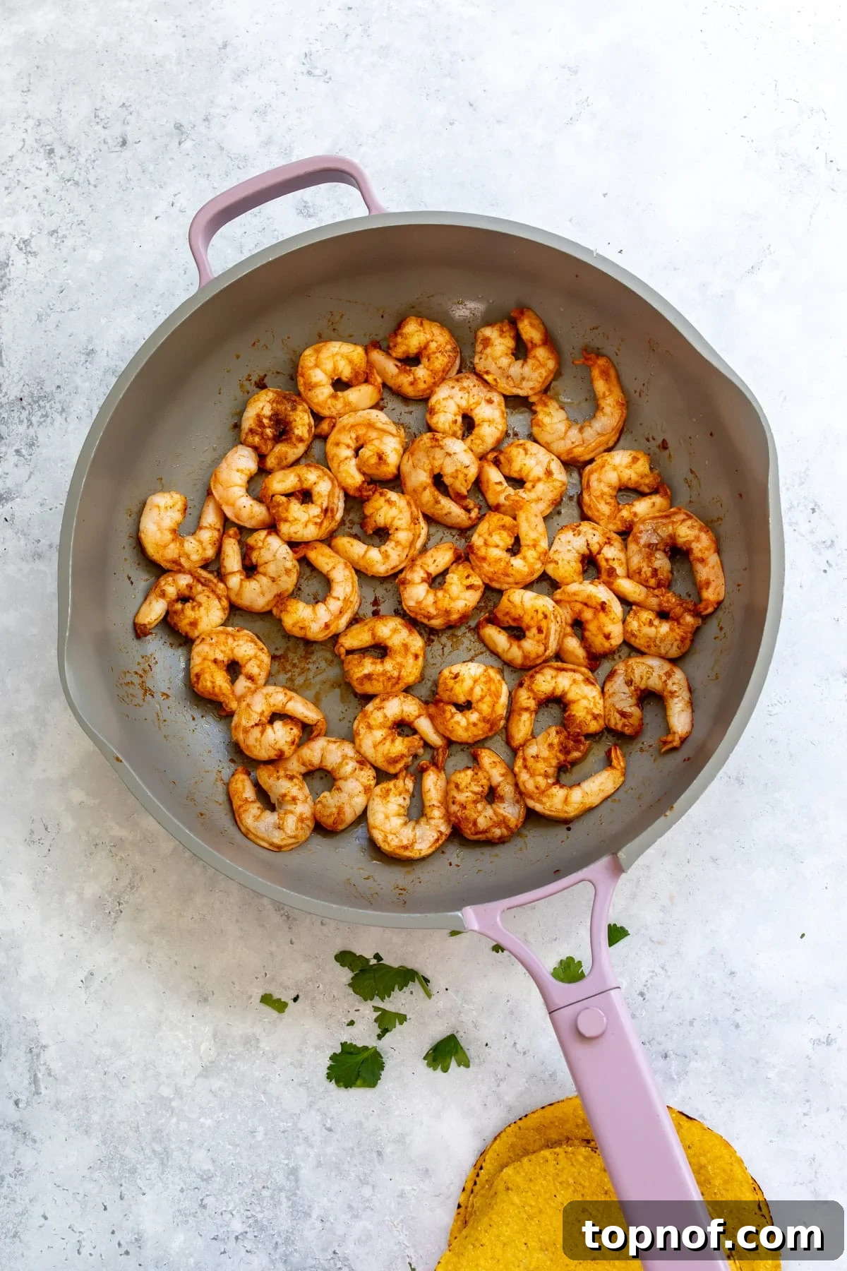 The shrimp cooked in the skillet.