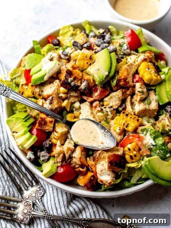 Spicy Southwest Salad in a white bowl on a counter with a towel to the side.